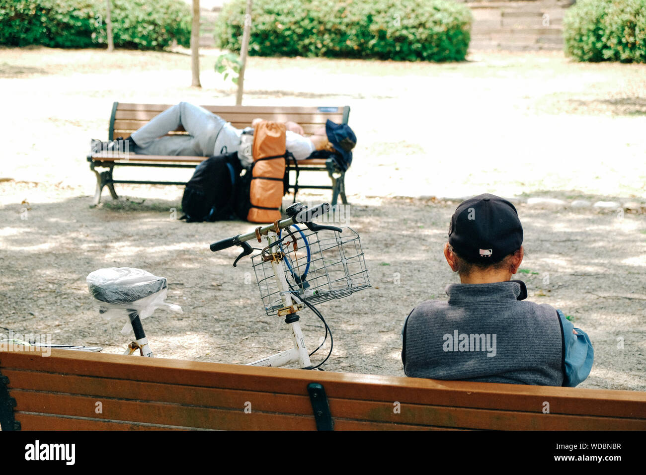 Two people sitting on benches hi-res stock photography and images - Alamy