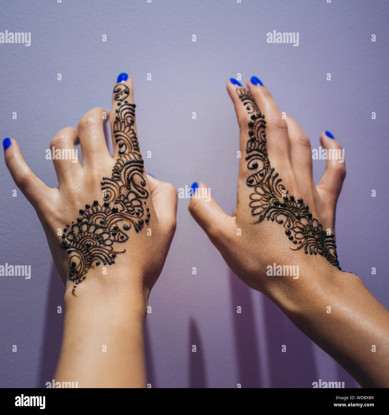 Cropped Hands Of Woman With Henna Tattoo By Wall Stock Photo Alamy