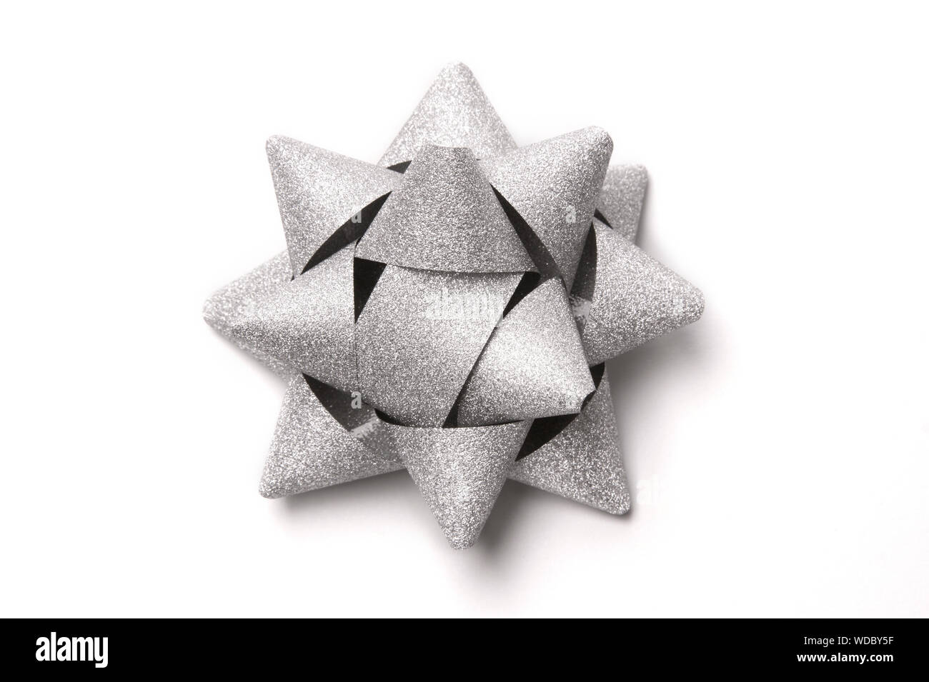 Silver glitter gift bow isolated on white. Stock Photo