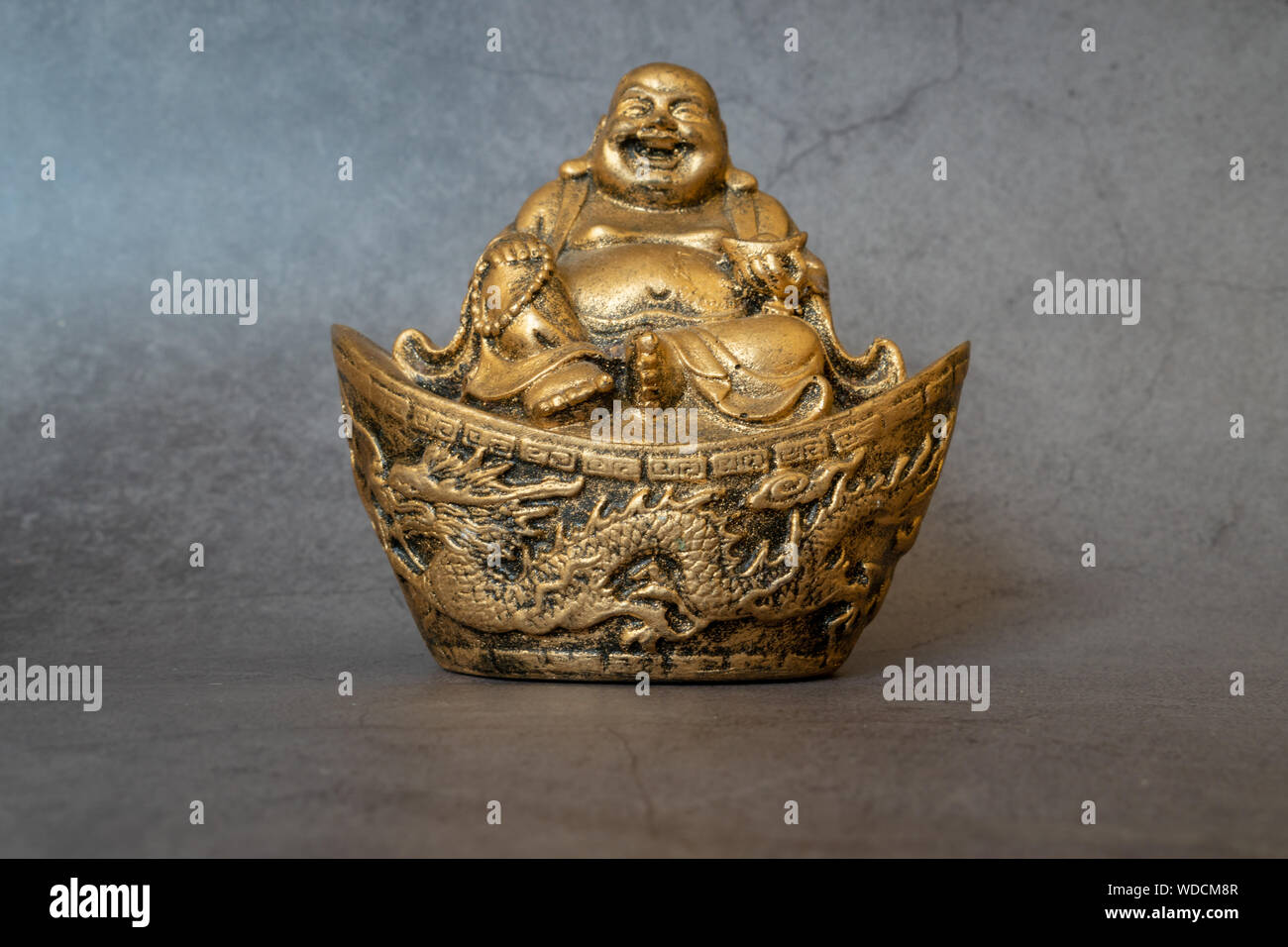 Figurine Cheerful Hotei - Image. Smiling Buddha - Chinese God of Happiness, Wealth and Lucky Isolated on gray - Image Stock Photo