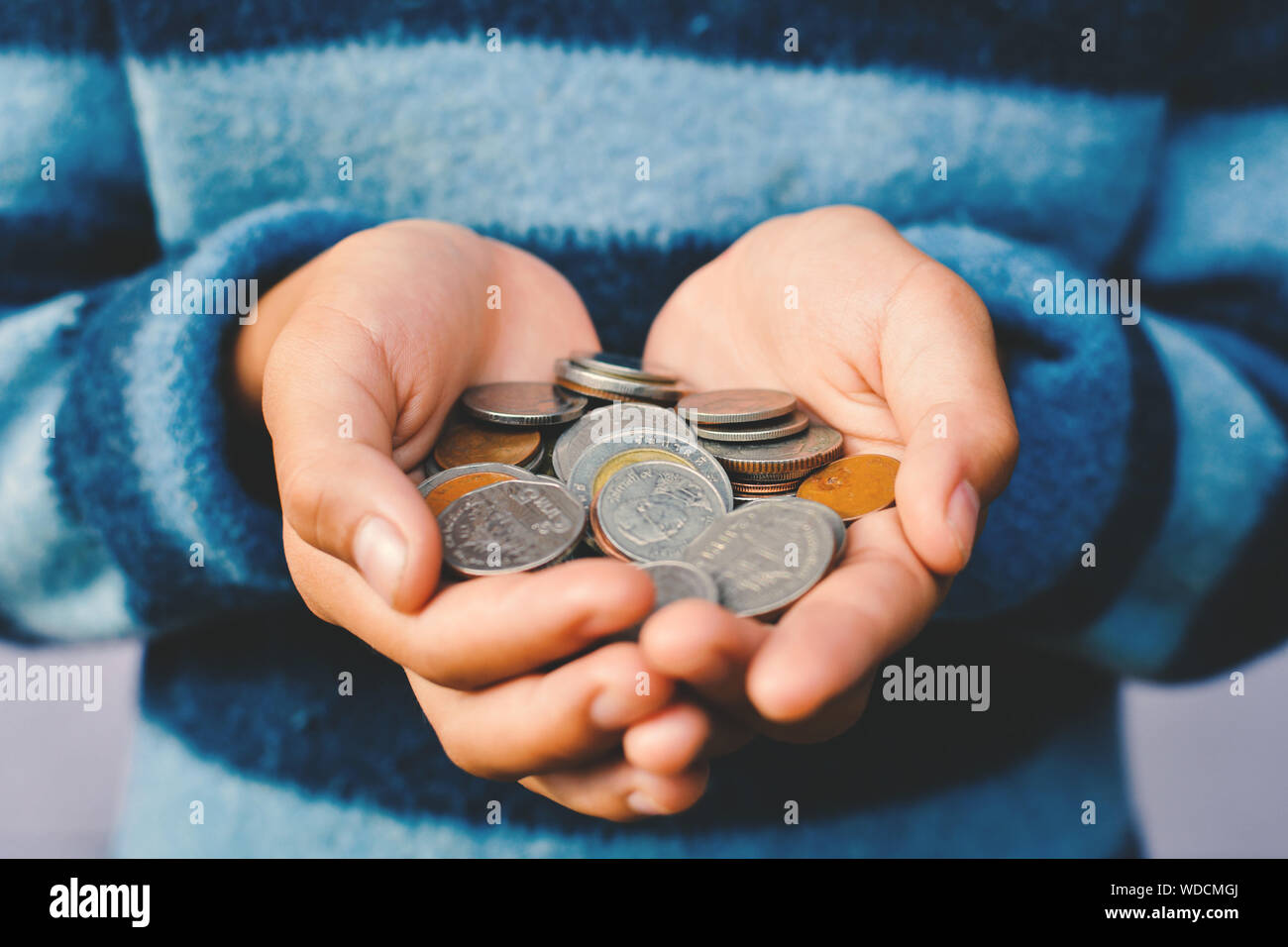 Midsection Of Woman Holding Coins Stock Photo