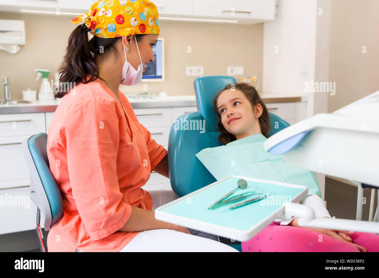 Pretty young girl a the dentist surgery for checkup with female dentist and assistant Stock Photo