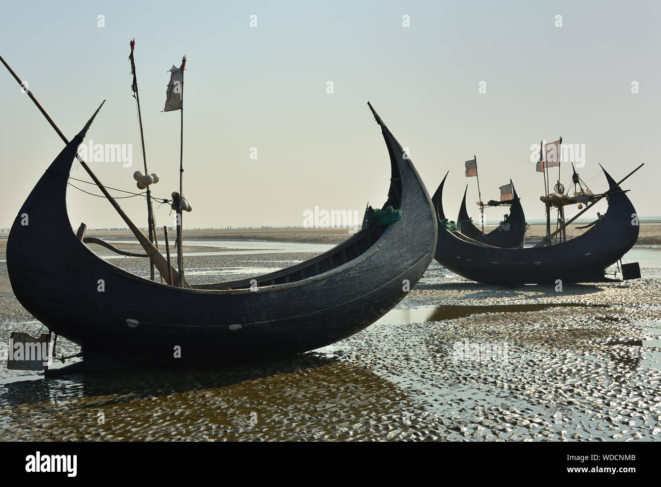 The traditional fishing boat (Sampan Boats) moored on the longest beach, Cox's Bazar in Bangladesh. Stock Photo