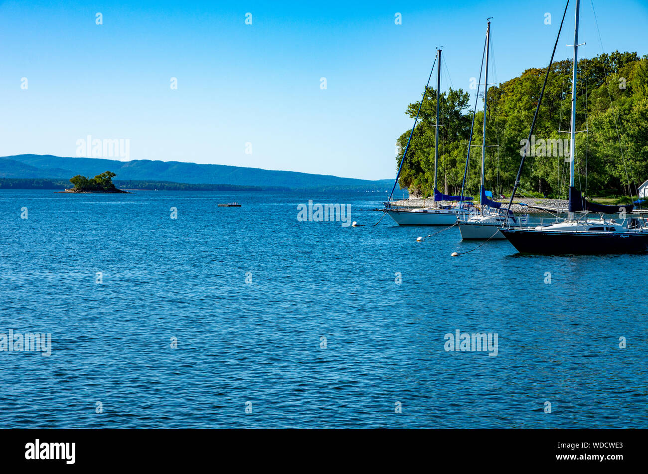 sailboats moored in a sheltered bay Stock Photo