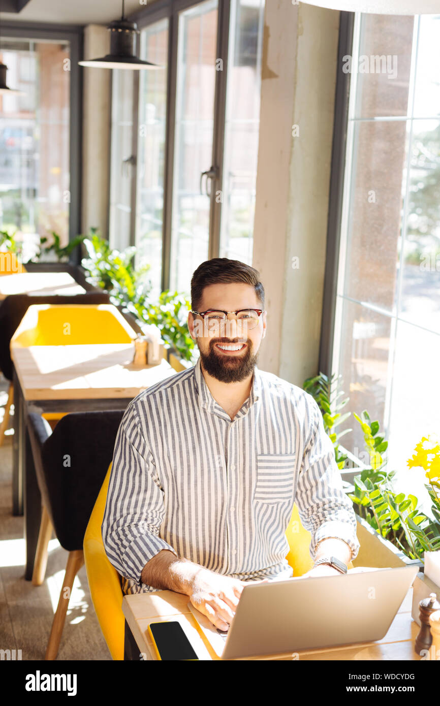 Nice handsome man working remotely on the laptop Stock Photo
