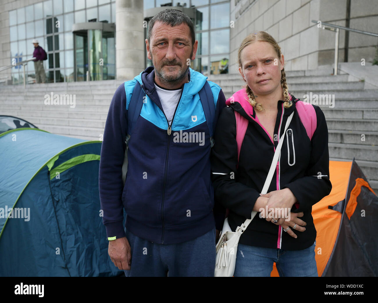 Homeless couple Wesley Condon and Sintija Klava, who lived in a tent for two years, pass an Inner City Helping Homeless protest outside Dublin City Council Offices on Wood Quay to highlight a marked increase in the number of people living in tents over the last month and the plight of homelessness. Stock Photo