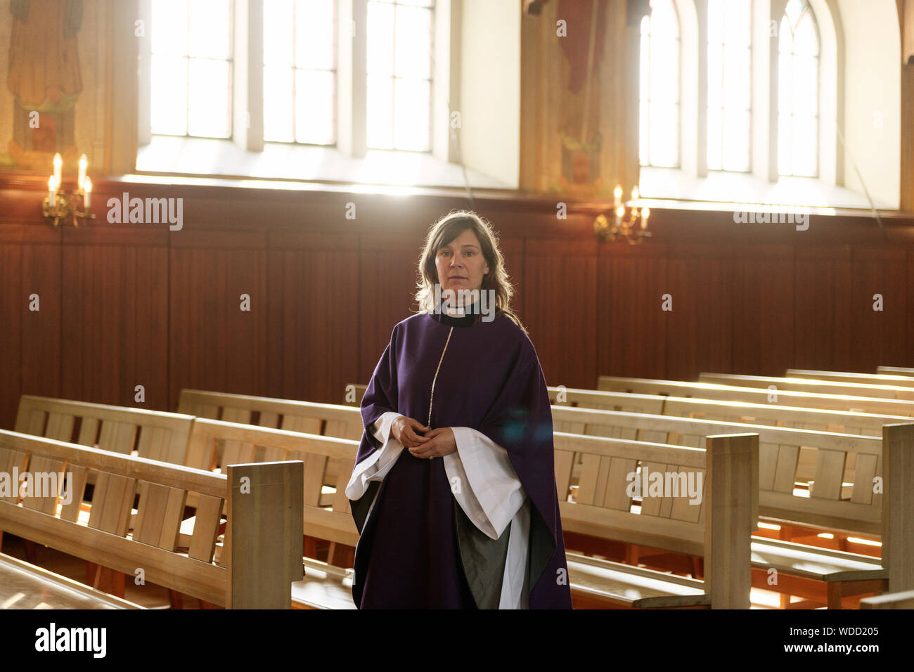 Portrait of priest in purple robes in church Stock Photo Alamy