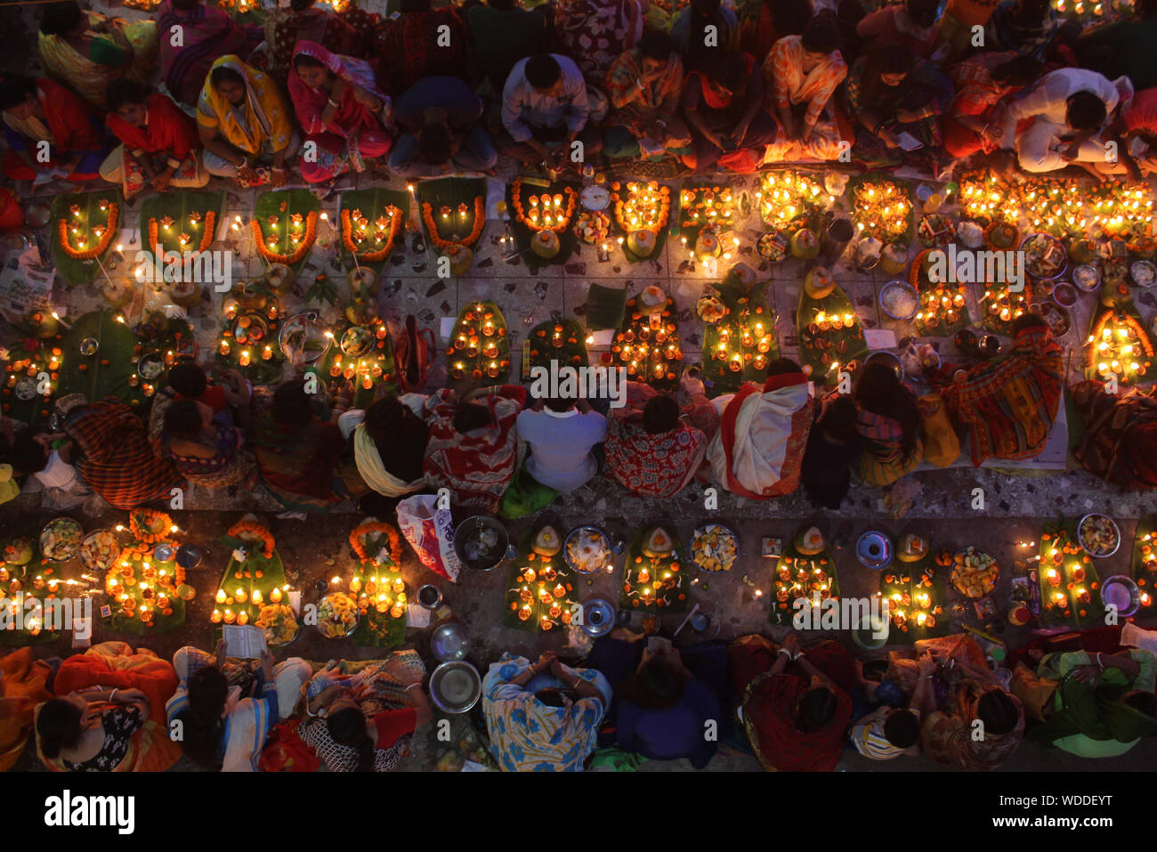 Directly Above Shot Of People With Illuminated Diyas During Religious Fasting At Night Stock Photo