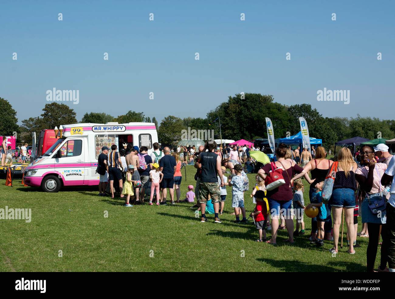 A queue at an ice cream van at the Party in the Park, Bank Holiday Monday, August 2019, St Nicholas Park, Warwick, England, UK Stock Photo