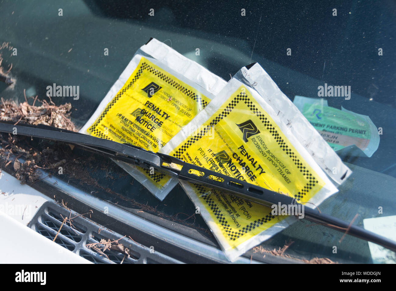 Two penalty charge notice tickets on a car windscreen in London, England, UK Stock Photo