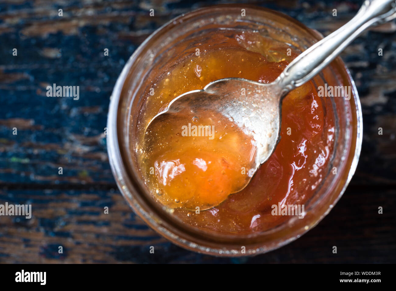 Directly Above Shot Of Stone Fruit Preserves In Jar On Wooden Table Stock Photo