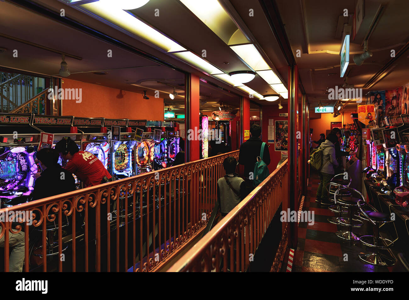 People play pachinko game inside Taito arcade store. Stock Photo