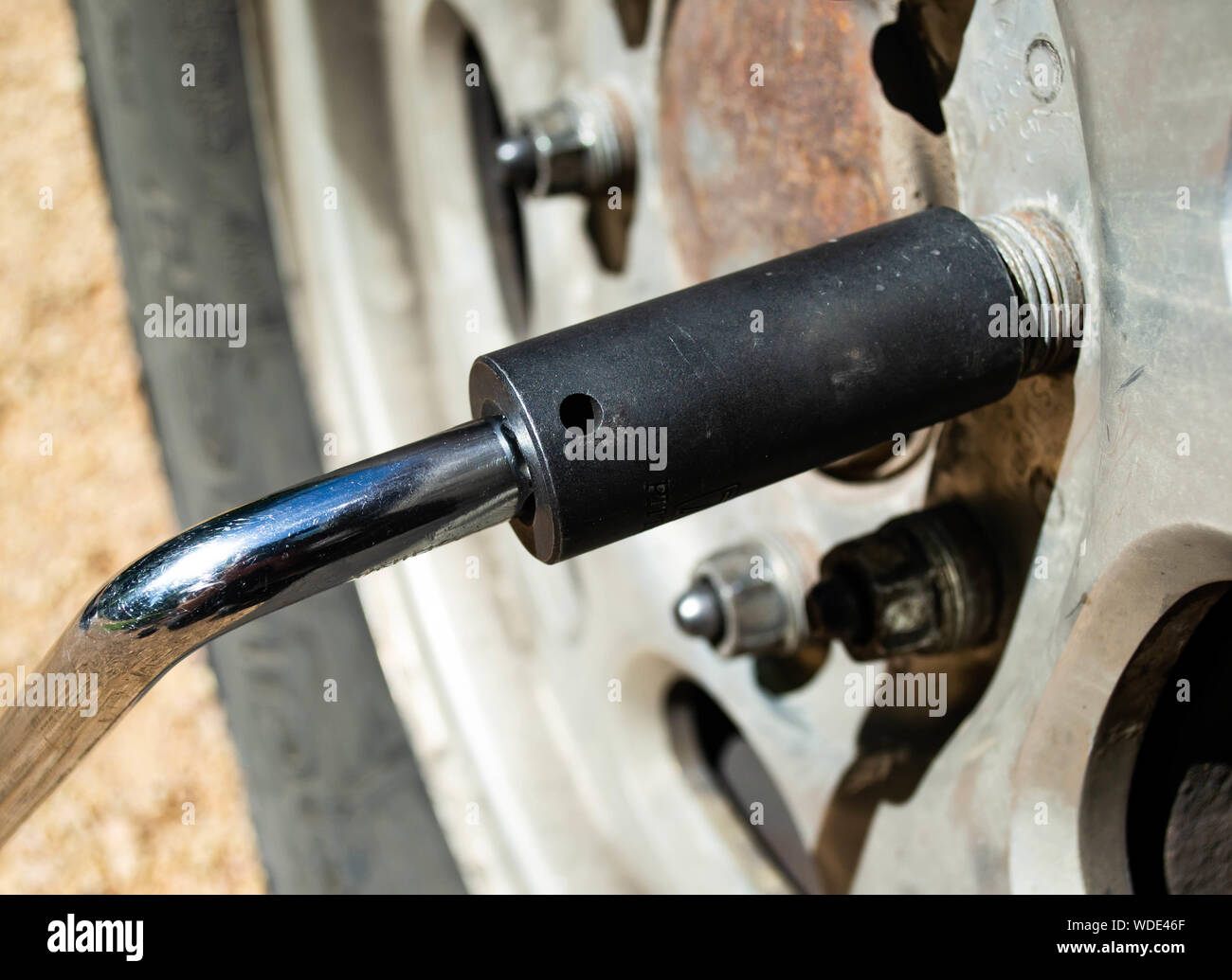 Victoria, MN August 19, 2019 A tire iron removing lug nuts from a