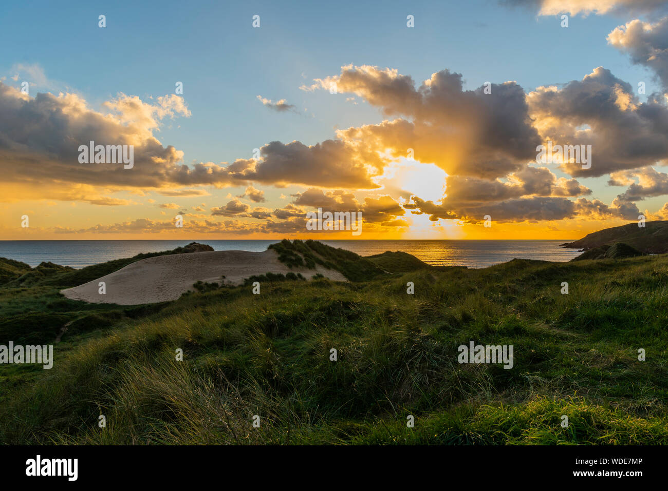 Sunset at Freshwater west beach, Wales. Looking across the dunes to the beach. Stock Photo