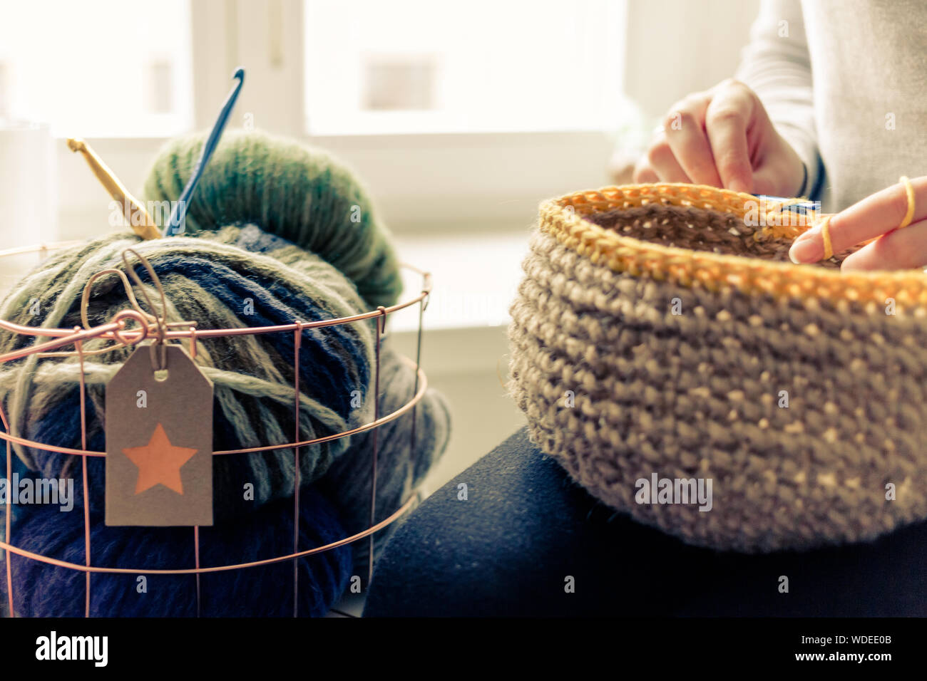 Midsection Of Woman Knitting Basket At Home Stock Photo