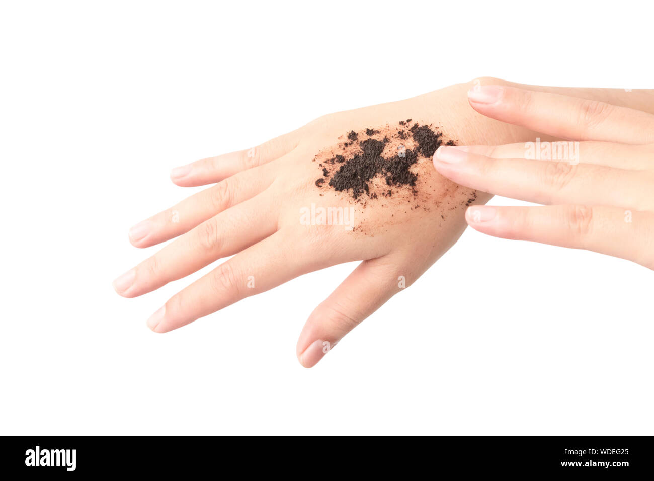 Cropped Image Of Woman Applying Coffee Scrub On Hand Against White Background Stock Photo