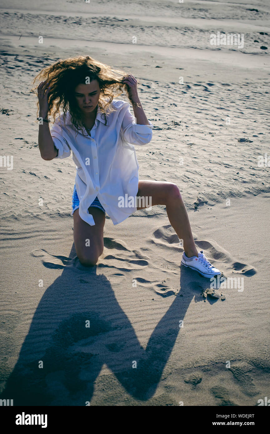 Young Woman Kneeling Beach High Resolution Stock Photography and Images ...
