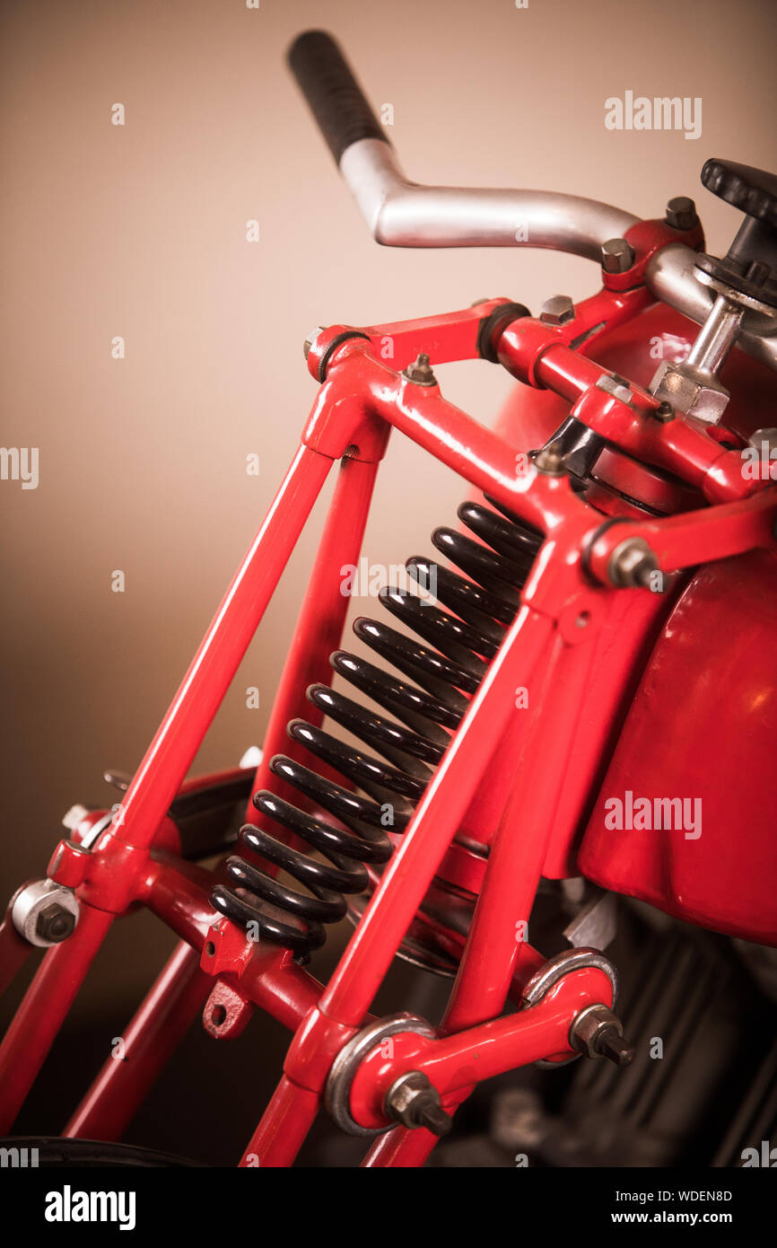 Color vertical close up of the front suspension of a red vintage