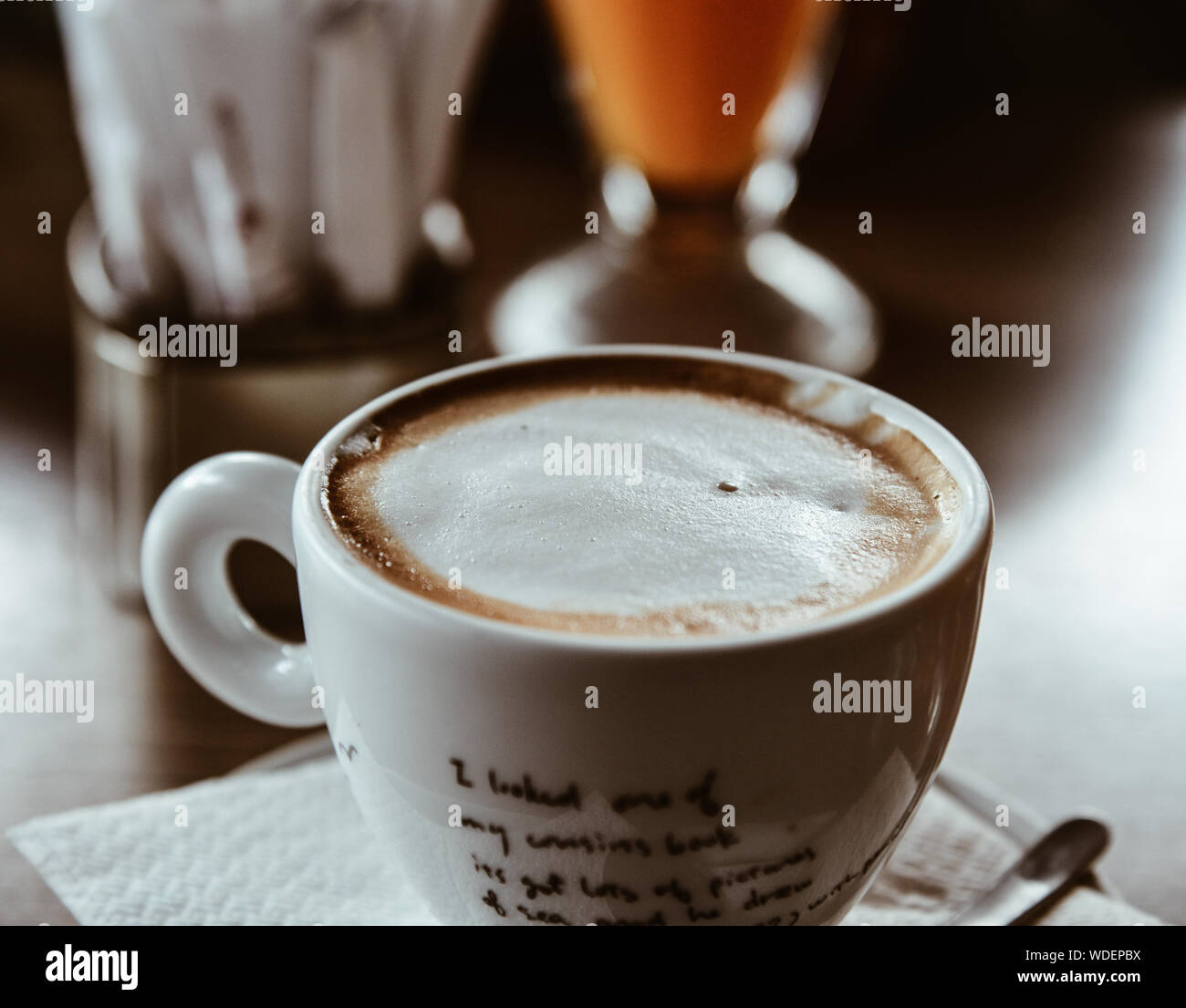 Cup of hot coffee with cream at cheap restaurant in Athens, Greece. Stock Photo