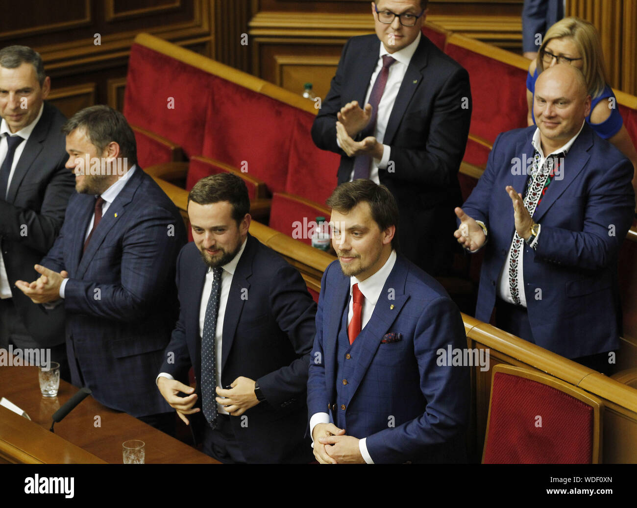Kiev, Ukraine. 29th Aug, 2019. Presidential Office's members congratulates newly elected Ukrainian Prime Minister OLEKSIY GONCHARUK (C) during a session of the Ukrainian Parliament in Kiev, Ukraine, 29 August 2019. The Ukrainian Parliament voted to appoint Oleksiy Goncharuk as Prime Minister of Ukraine. Th''‹e first parliamentary session following the July extraordinary Parliament's elections in the country took place in Kiev. Credit: Serg Glovny/ZUMA Wire/Alamy Live News Stock Photo