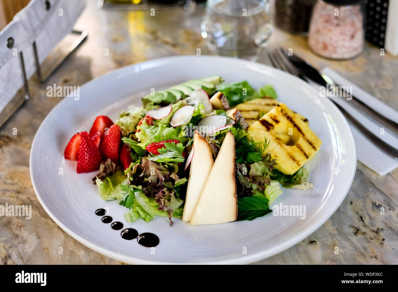 Cheese salad on a marble table. Organic salad. Stock Photo