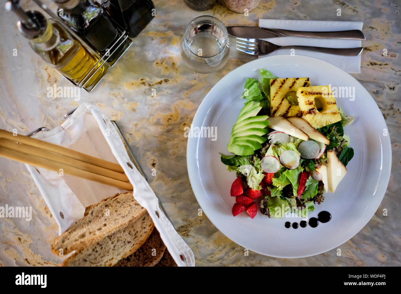 Cheese salad on a marble table. Organic salad. Stock Photo