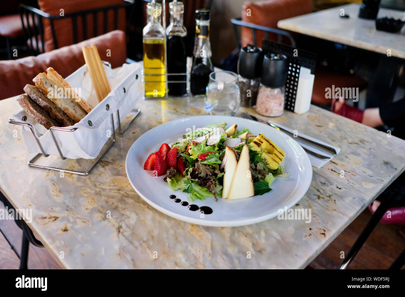 Cheese salad on a marble table. Organic salad. Stock Photo