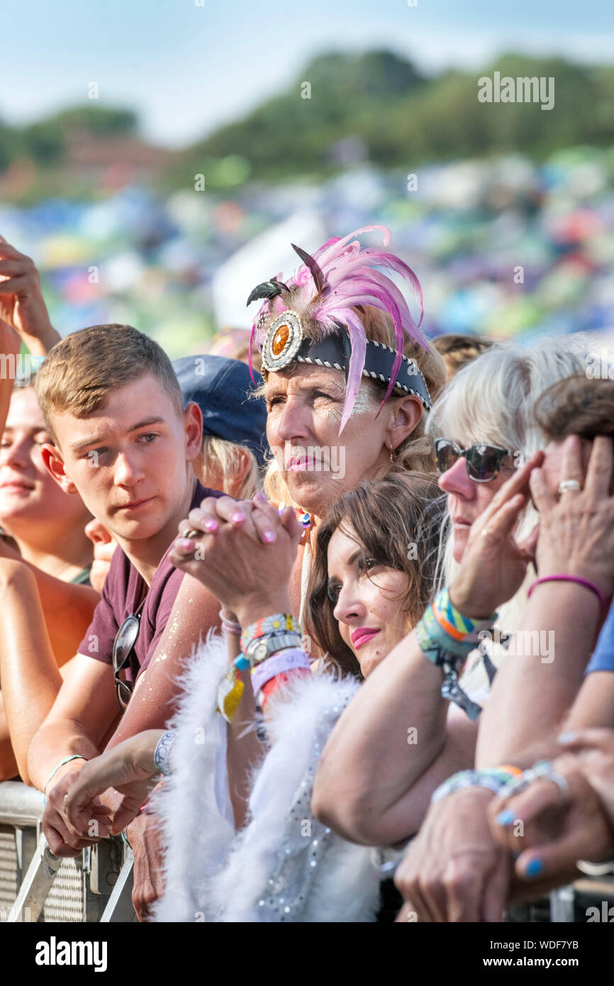 An older visitor to the Glastonbury Festival 2019 in Pilton, Somerset -  these fans wait for Lauryn Hill to perform on the Pyramid Stage Stock Photo  - Alamy