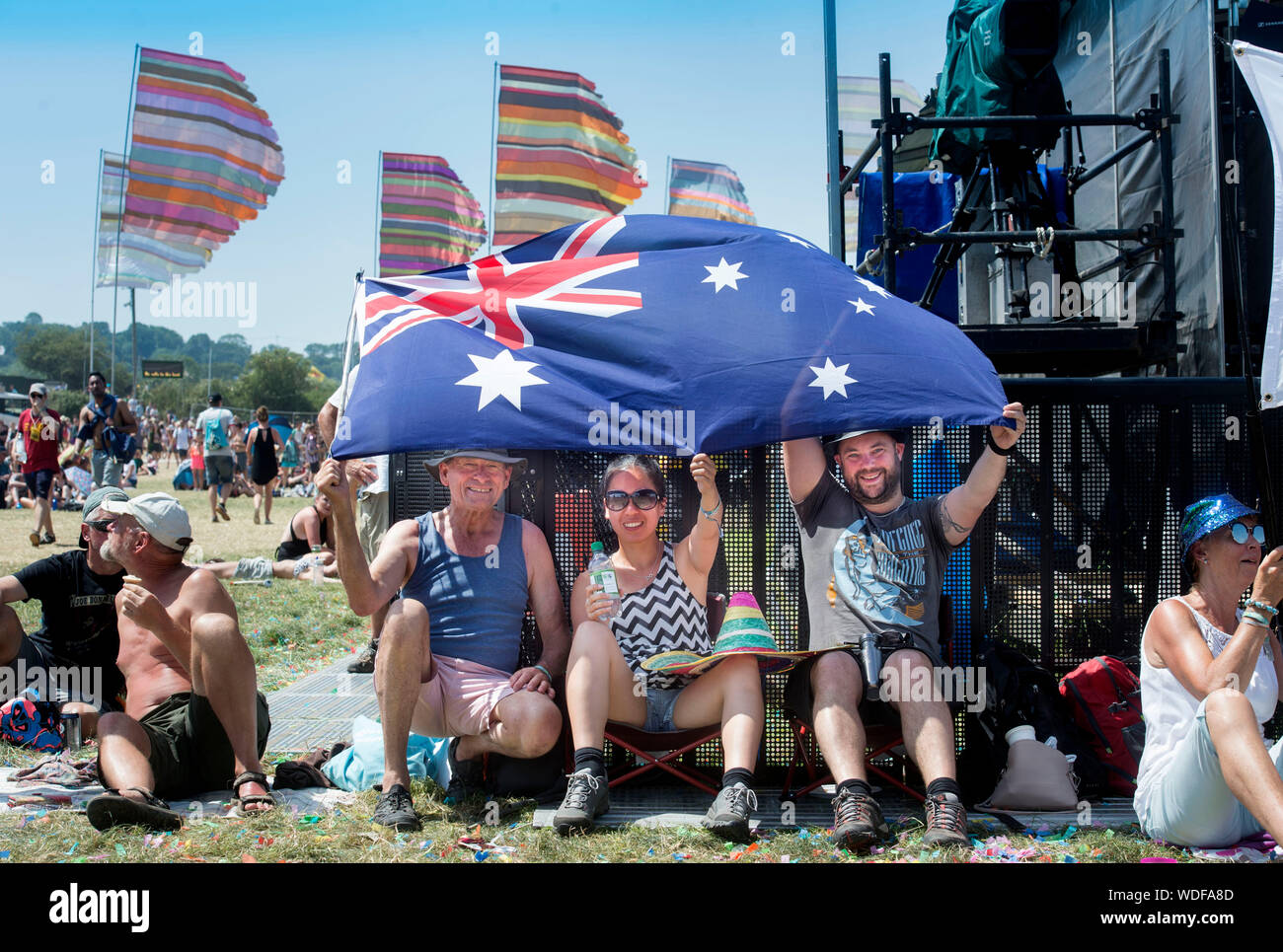 Even hot for Australians - Andy Croud & fiancee Hanh Hua from Sydney with Ray Birch (left) from Brisbane, near the Other Stage at the Glastonbury Fest Stock Photo