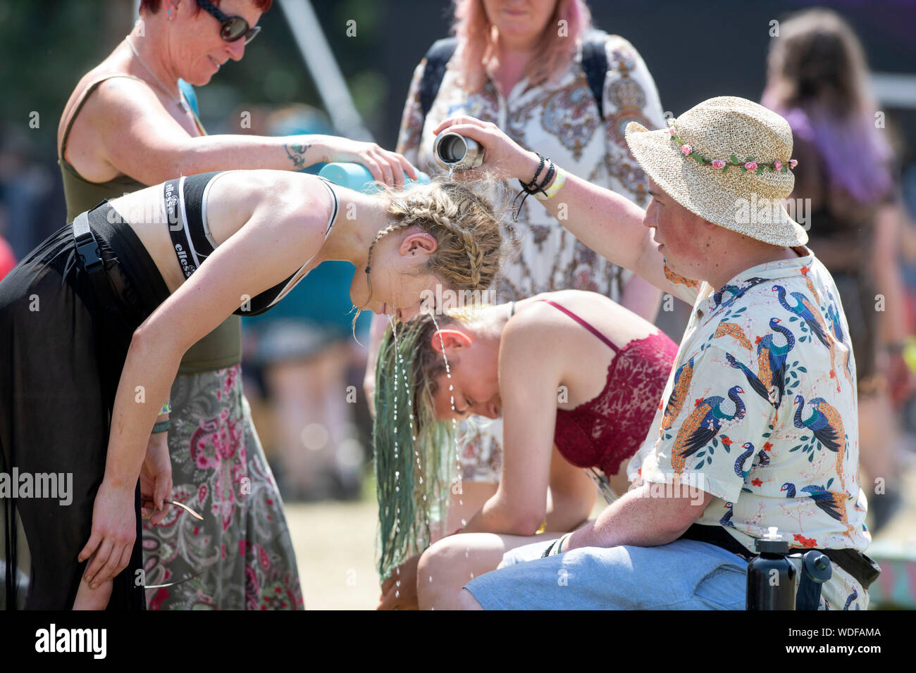 A family cooling off near the Other Stage at the Glastonbury Festival 2019 in Pilton, Somerset Stock Photo