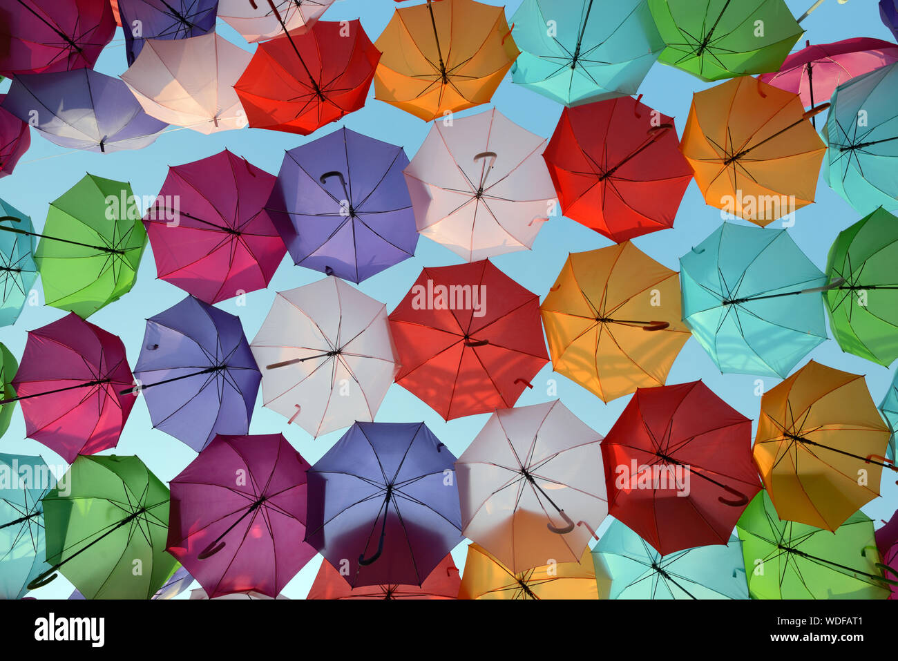 Colourful Parasols or Umbrellas Hanging Above Place Francois Villon, by Artist Patricia Cunha Umbrella Sky Project Art Installation Aix-en-Provence Stock Photo