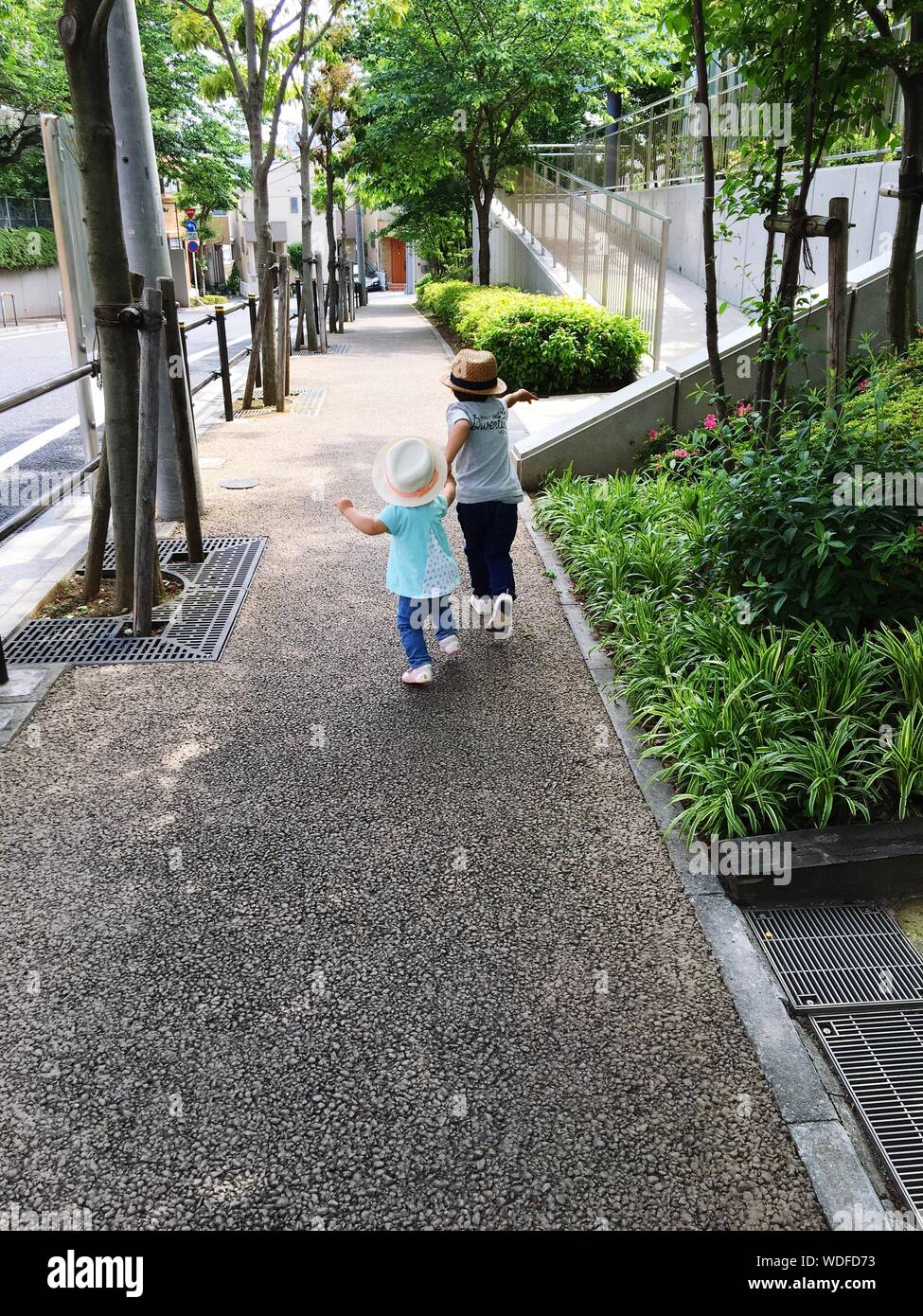 Children Running On Pedestrian Walkaway Stock Photo