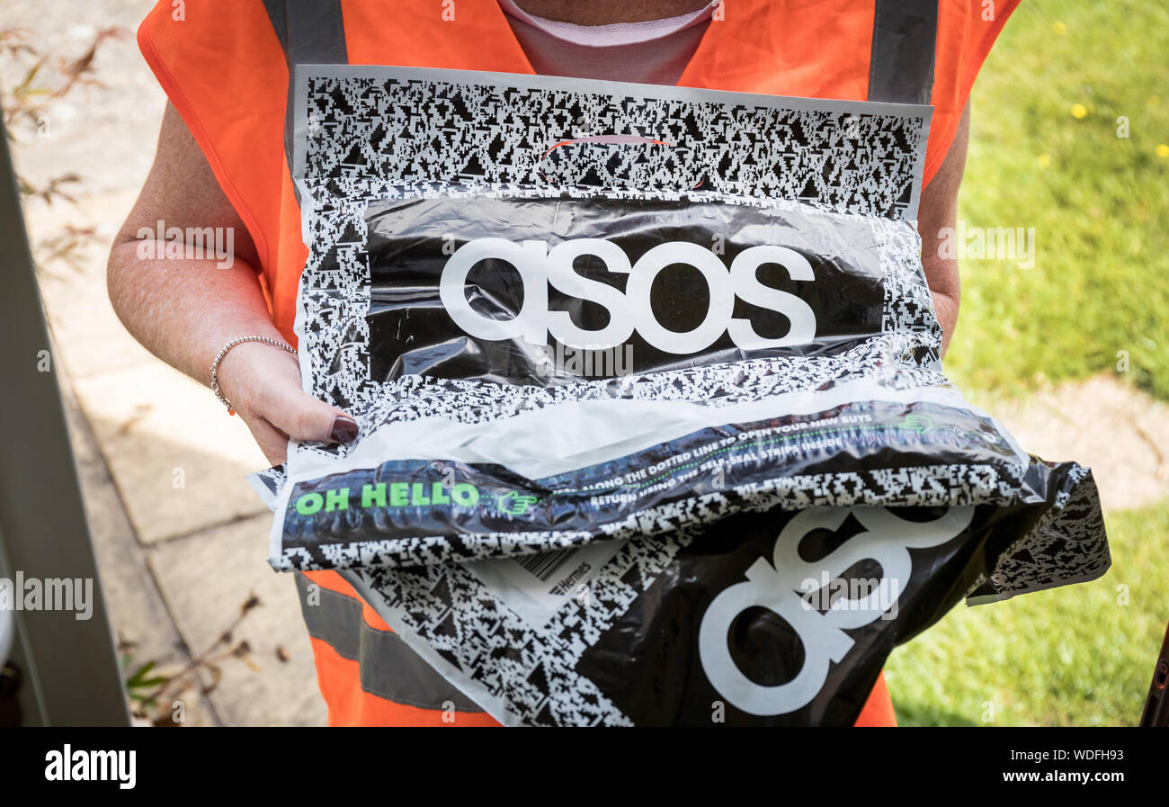 A woman delivering a package from asos, the online fashion clothing website Stock Photo