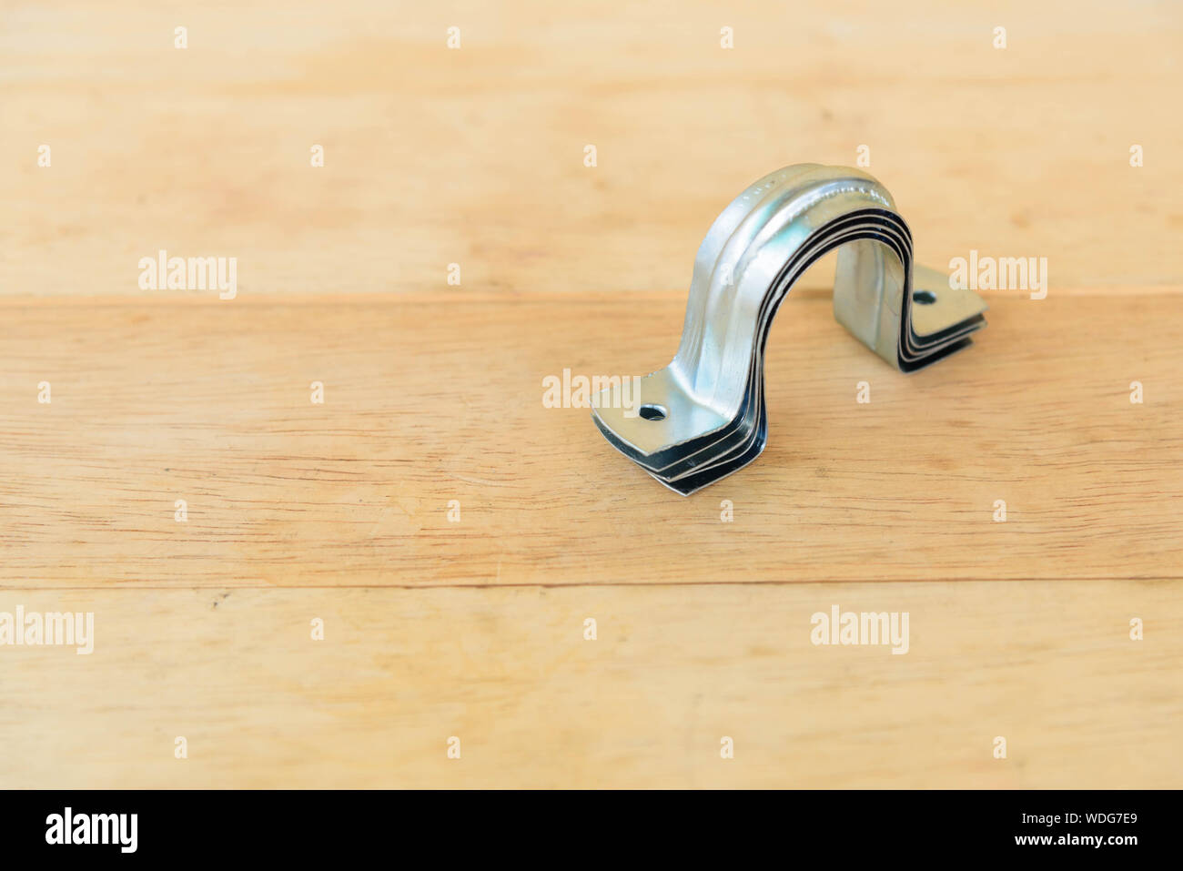 clamp lock for pipe on wood plated Stock Photo Alamy