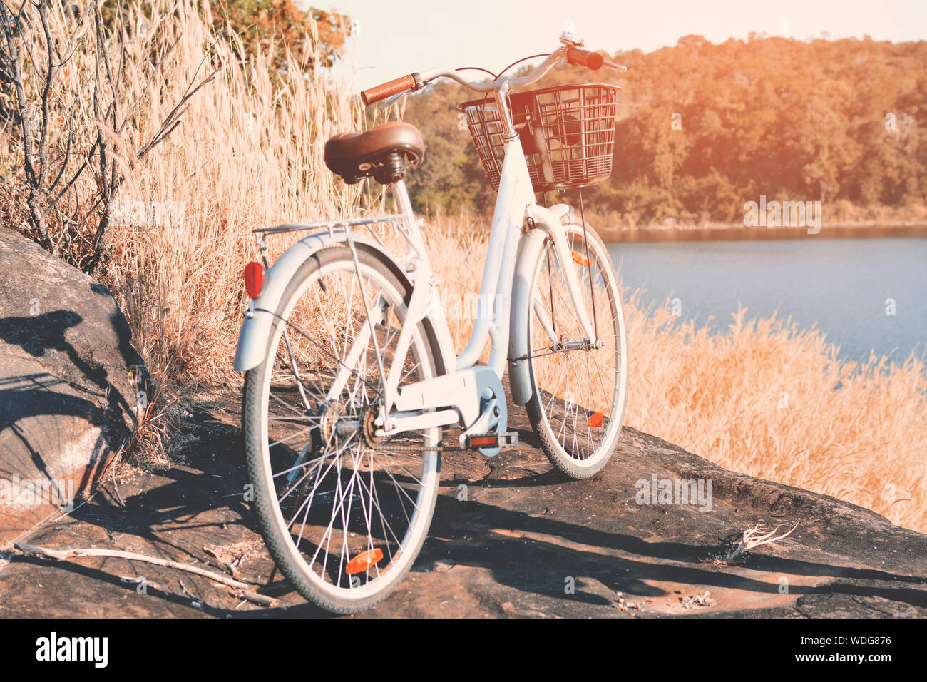 Bicycle Parked On Rock By Lake Stock Photo