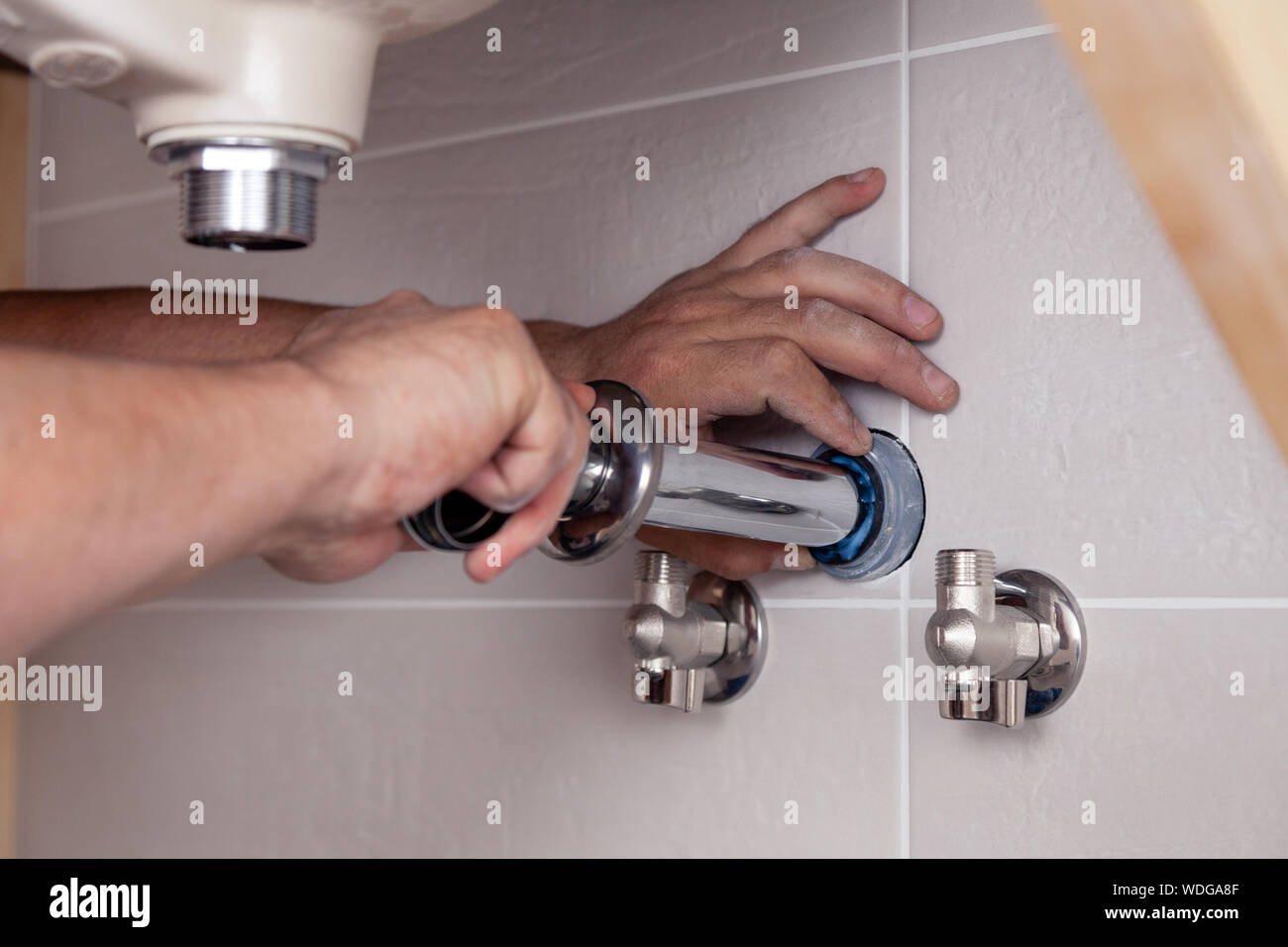 Closeup Male Plumbers Hand Fixing Sink In Bathroom With Tile Wall Professional Plumbing Repair Service