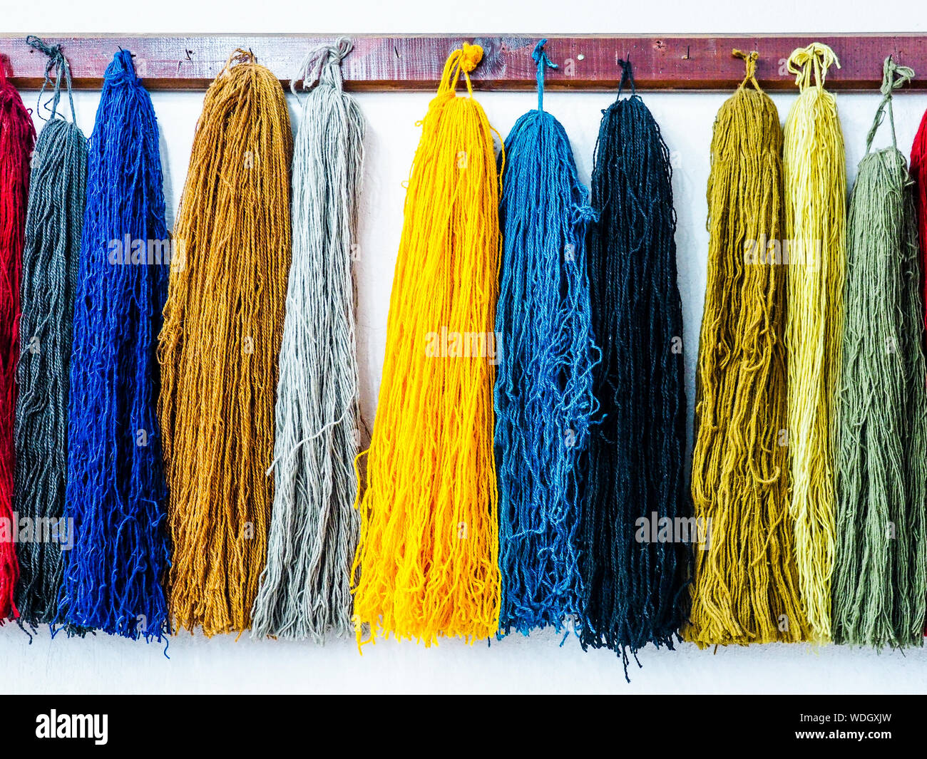 Various Silk Threads Hanging From Hooks In Carpet Factory Stock Photo