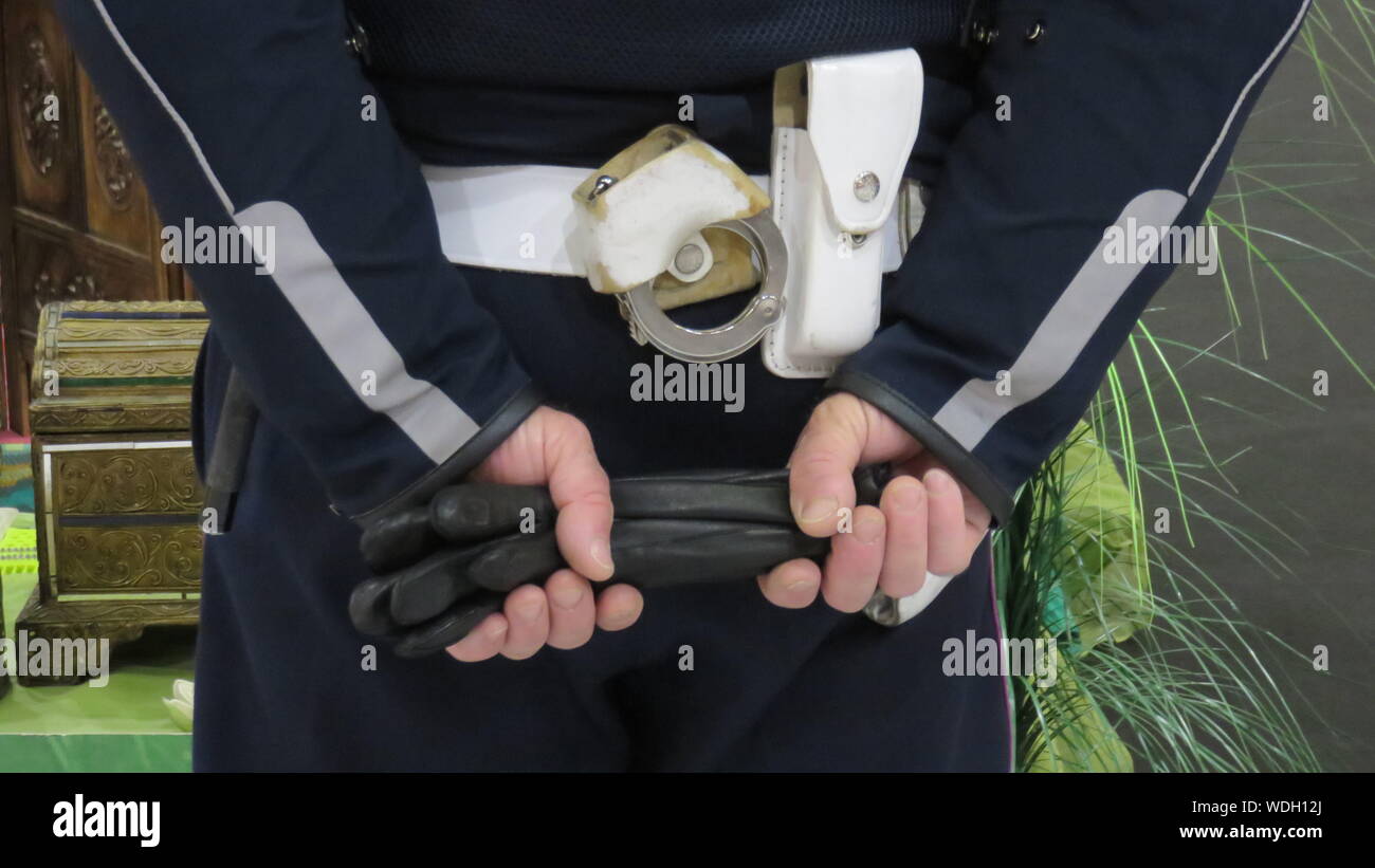 Midsection Of Male Police Officer Holding Protective Glove Stock Photo