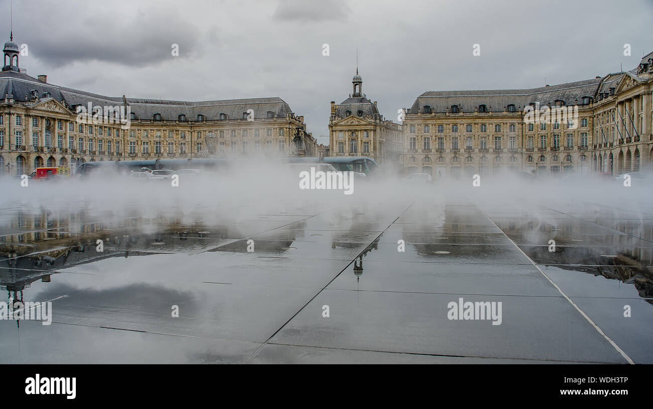 Neoclassical buildings in the water mirror of the Place de la Bourse de Bordeaux Stock Photo