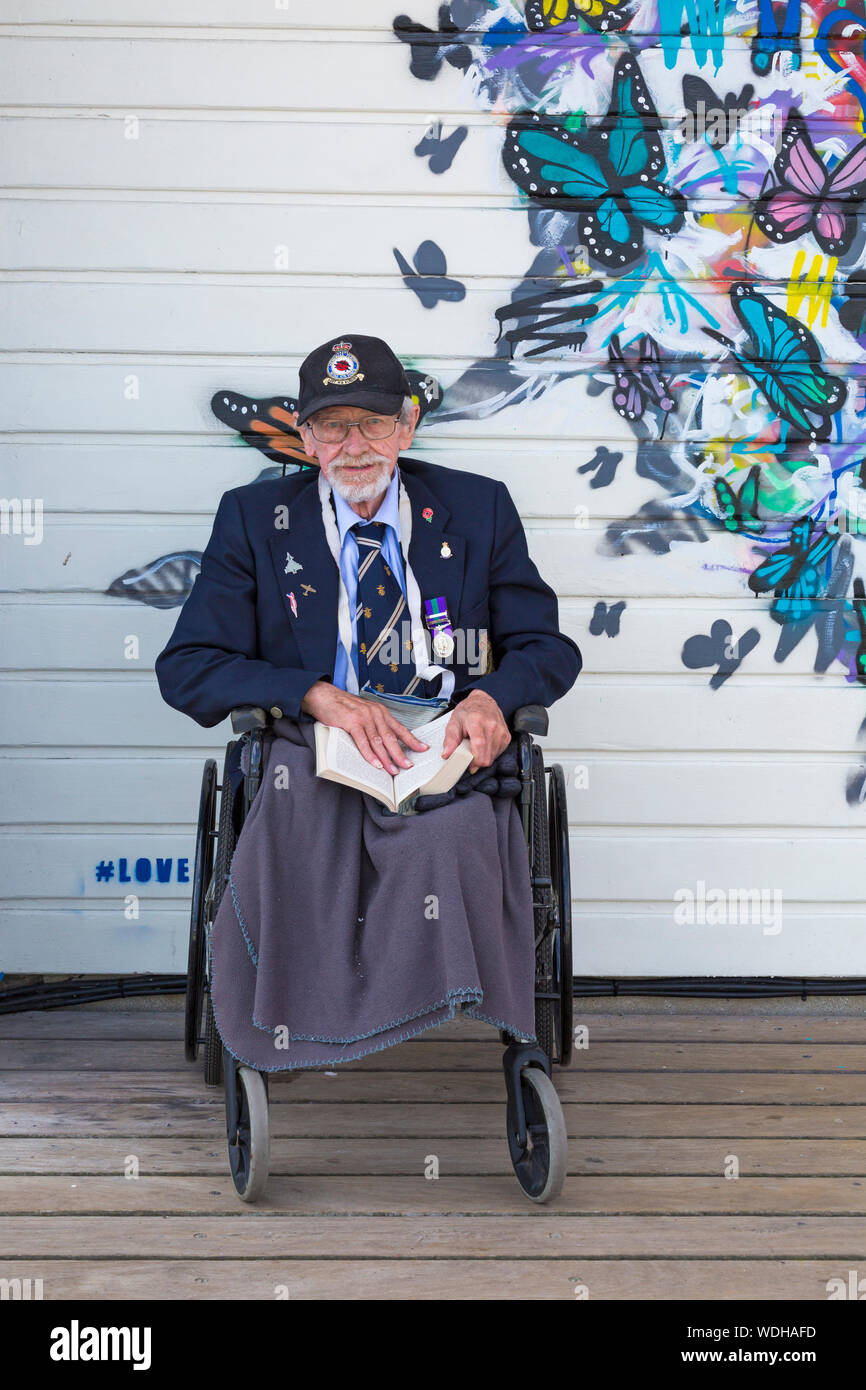Bournemouth, UK. 29th August 2019. Up to a million people are set to descend on Bournemouth over the next four days as the 12th annual Bournemouth Air Festival gets underway. Veteran Peter, aged 87, served in the RAF ground crew for Lancaster Squadron 1948 - he reads his book before the show starts, but looking forward to seeing the planes. Credit: Carolyn Jenkins/Alamy Live News Stock Photo