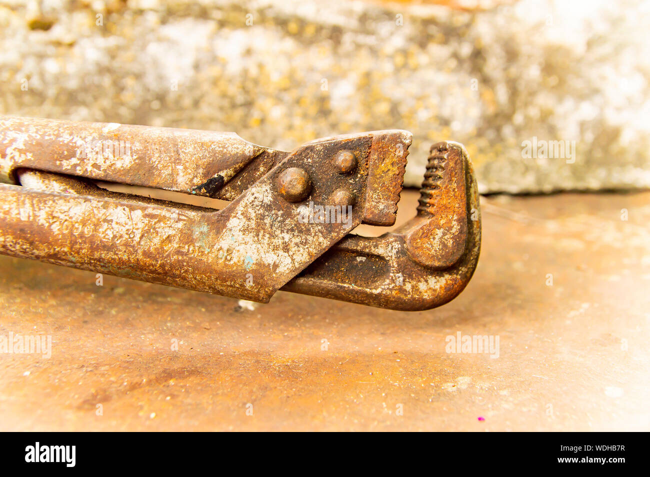 Old plumbing wrench - working tool. Background. Stock Photo