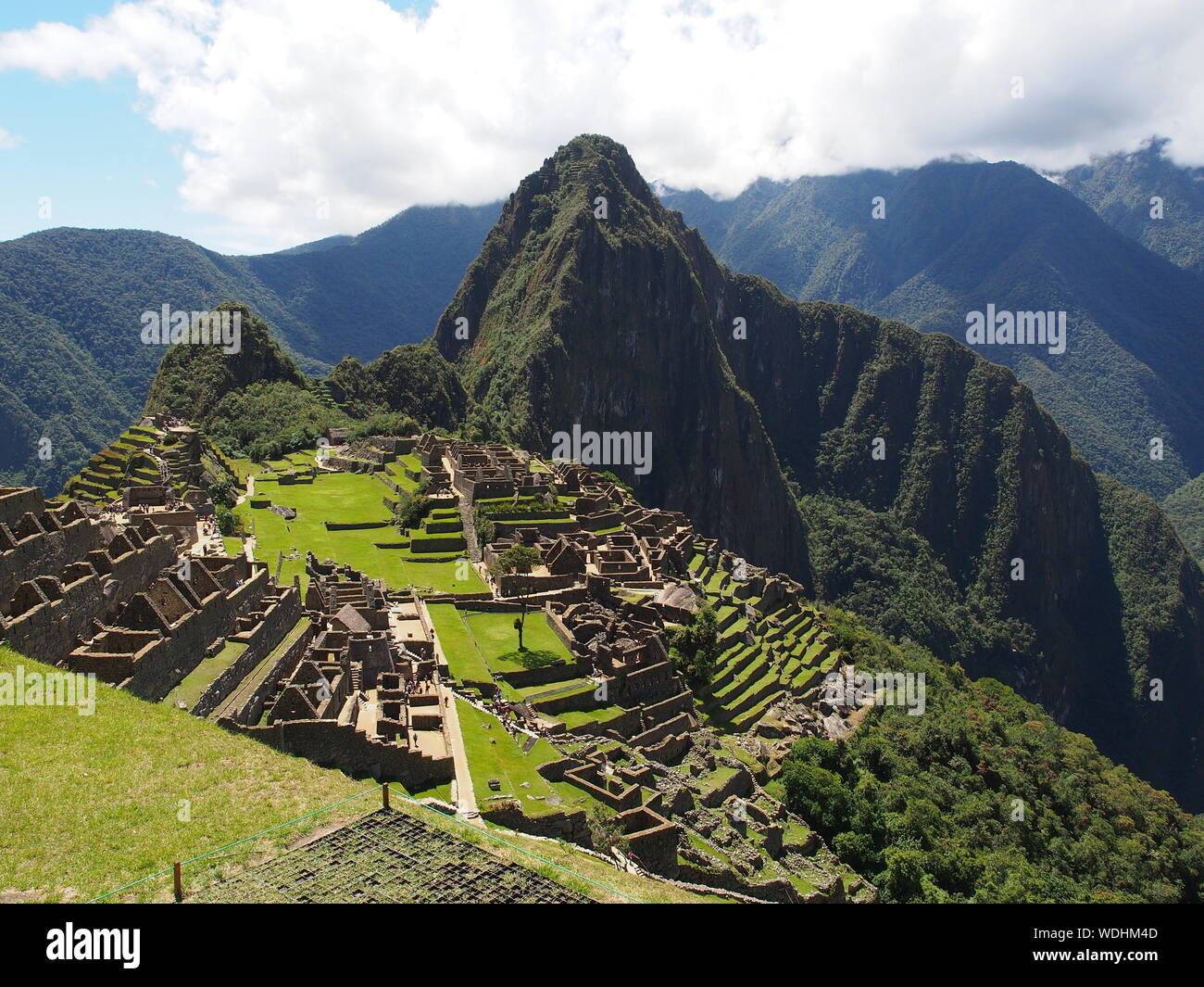 Sunny view of  Machu Picchu, a 15th-century Inca citadel located in the Cusco Region, Urubamba Province, Machupicchu District, Peru Stock Photo