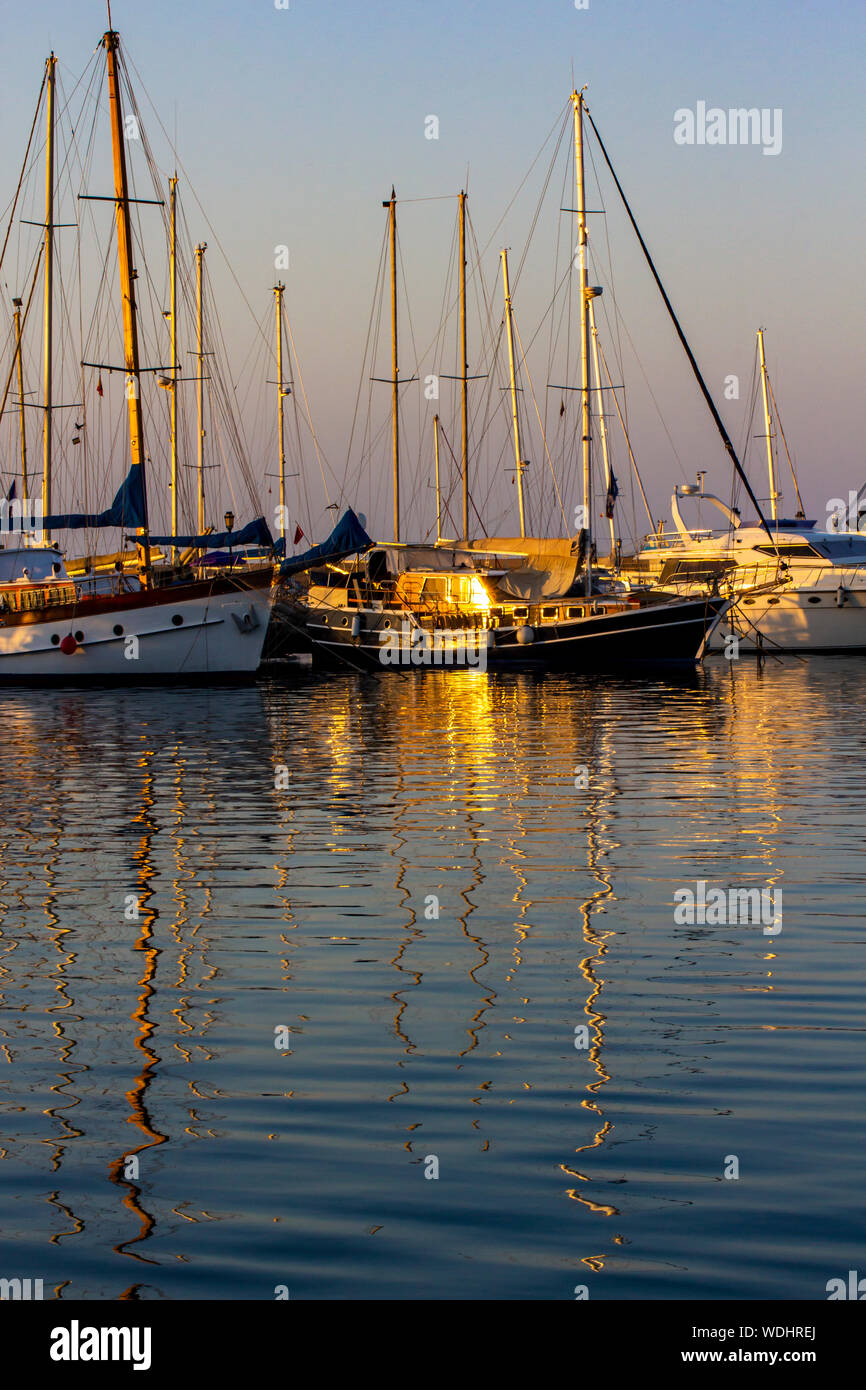 Reflections in the sea of some sailboats Stock Photo - Alamy