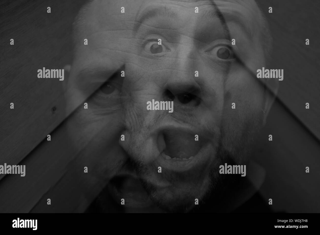 Double Exposure Of Man With Facial Expression Stock Photo