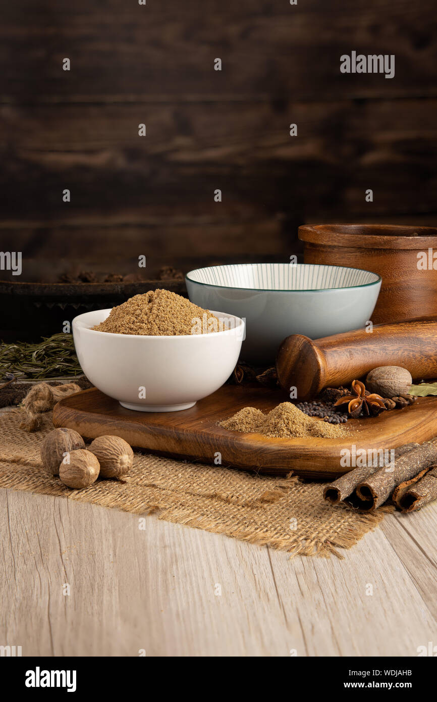 Ground coriander seed in a bowl and food preparation and kitchen setting Stock Photo