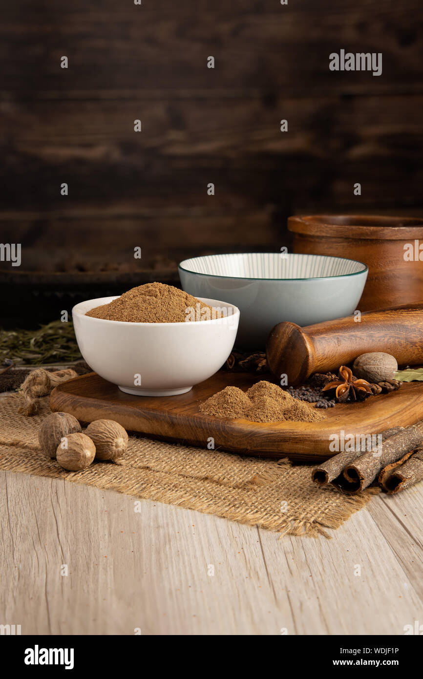 GROUND NUTMEG in a bowl and food preparation and kitchen set Stock Photo