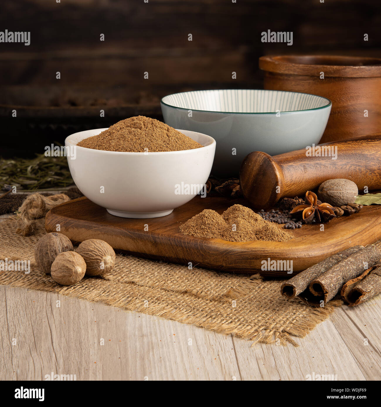 GROUND NUTMEG in a bowl and food preparation and kitchen set Stock Photo
