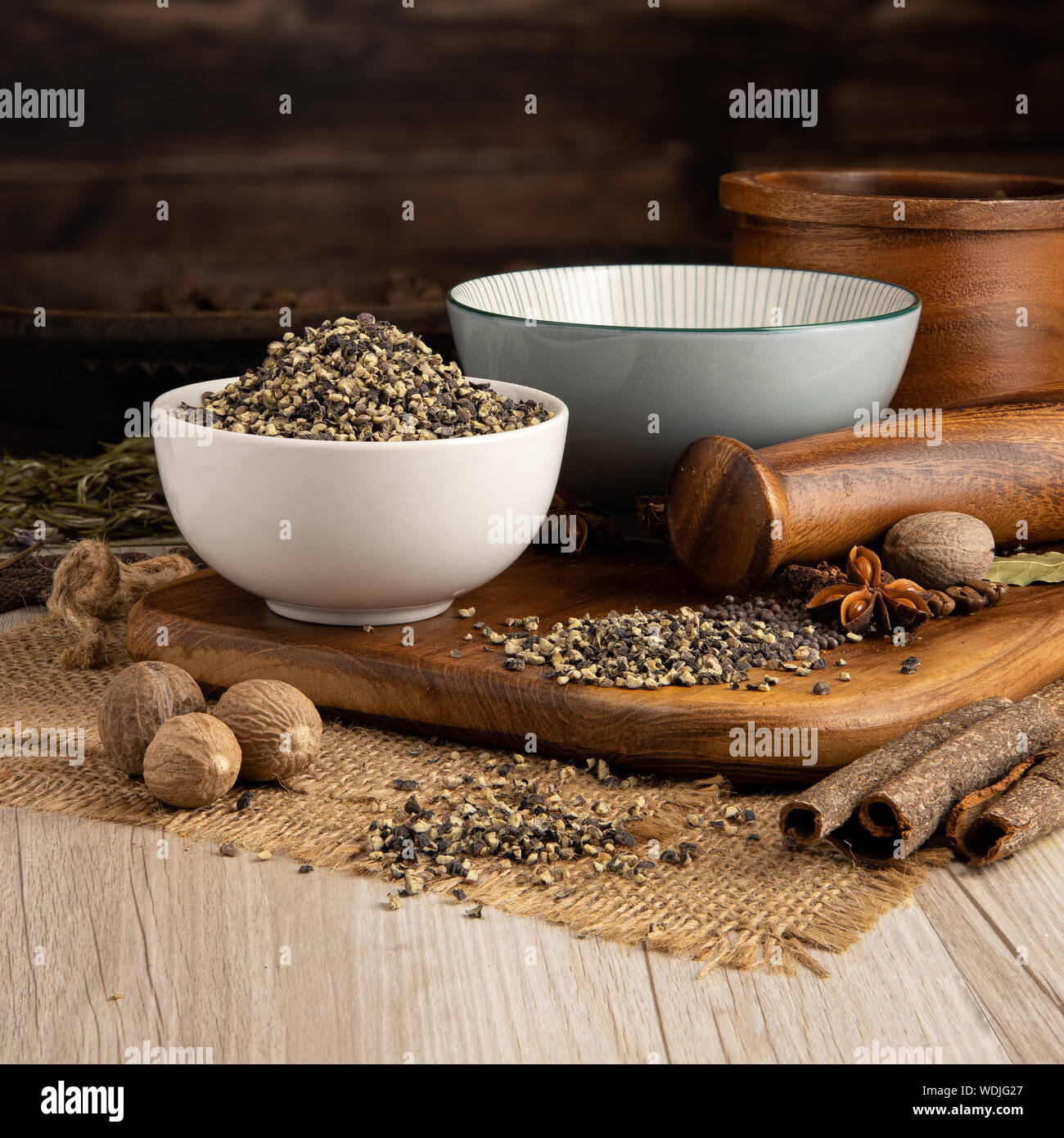 CRACKED BLACK PEPPER in a bowl and food preparation and kitchen set