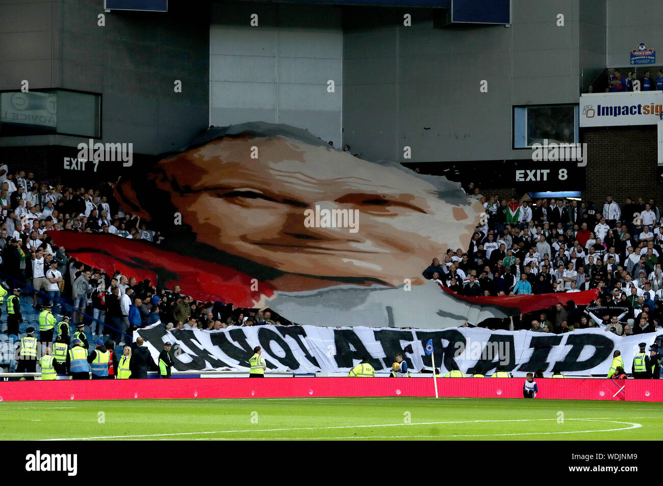Legia Warsaw fans unveil a banner of Pope John Paul II and one that reads 'Be Not Afraid' during the UEFA Europa League match at Ibrox Stadium, Glasgow. Stock Photo