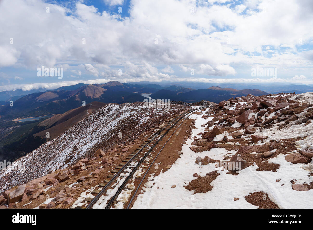 High in the clouds are the train tracks that sit on the top of the mountain. Stock Photo